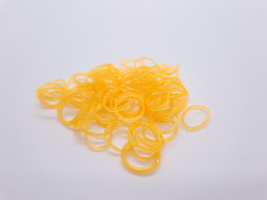 Transparente, orange glitzernde Gummi-Knotengummis